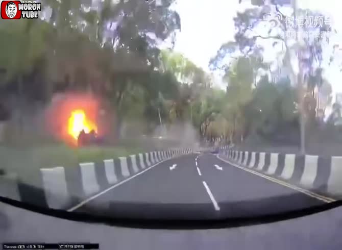 Video :A motorist takes a bend a little too fast, his car flies off the road and catches fire
